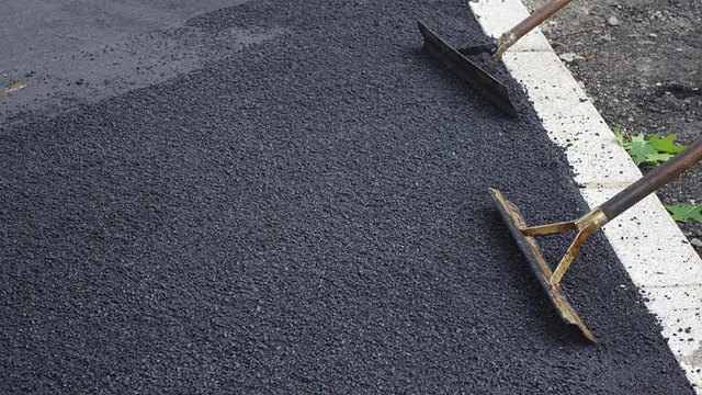 Tarmac being laid during a driveway installation